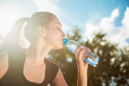 A woman drinking water.