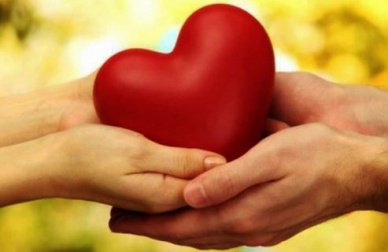 Couple holding a heart in their hands