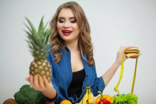 A woman picking out a pineapple.