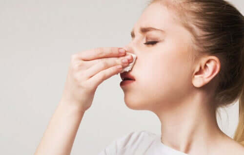 A woman trying to stop a nosebleed.