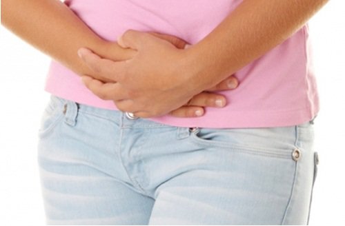Woman touching her lower abdomen