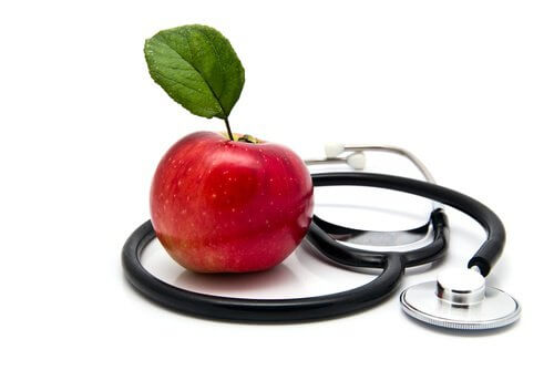 Apple next to a stethoscope