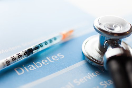 Insulin shot next to a diabetes pamphlet