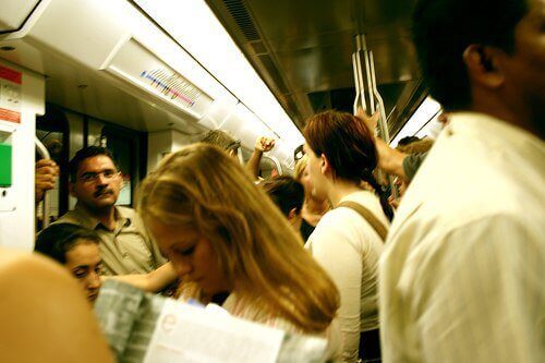Many people on a subway possibly going to work