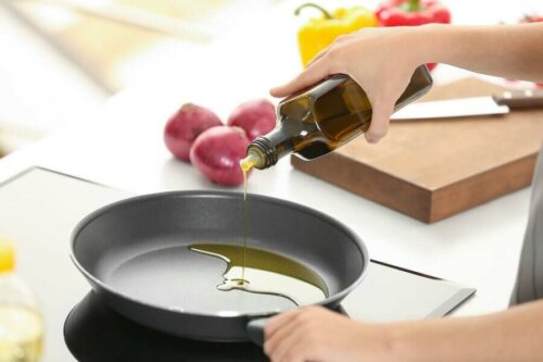 A woman cooking with healthy olive oil.