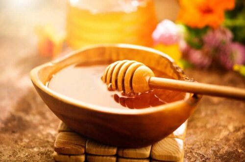 honey in a wooden bowl in the sun