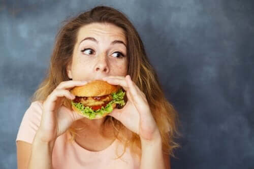 A woman eating a burger.