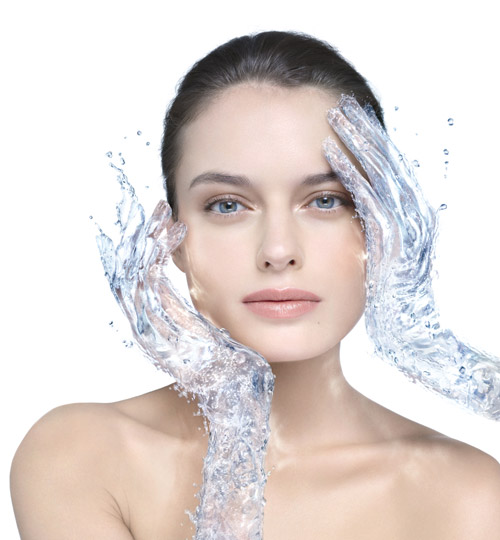 A woman with hands made of water touching her face.