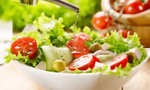 A salad with a drizzle of extra virgin olive oil.