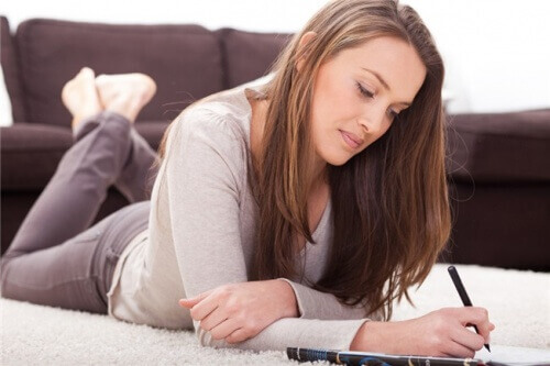 A woman writing in her journal