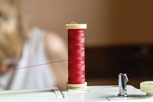 A spool of red threat ready to be used.