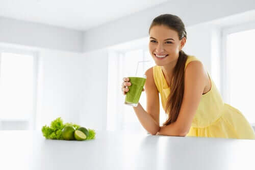 A woman happy she's drinking a natural remedy to lower cholesterol.