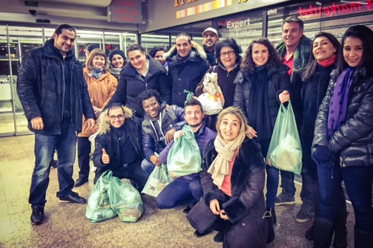 A group of people donating products so they do not end up as food waste