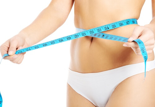 Woman measuring her waist