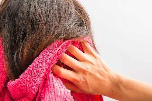 Woman drying hair with towel