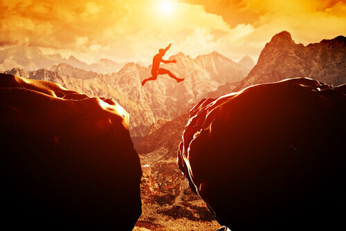 A man jumping over a precipice.