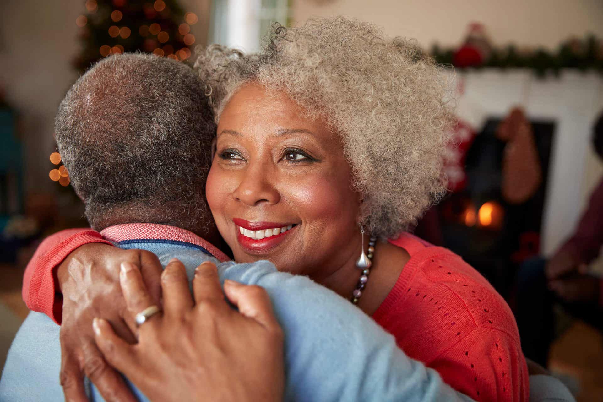 An older couple embracing.