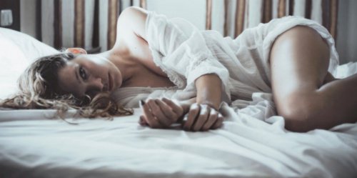 Woman laying in bed possibly thinking about her partner