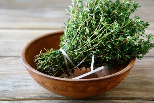 A bunch of thyme in a wooden bowl.