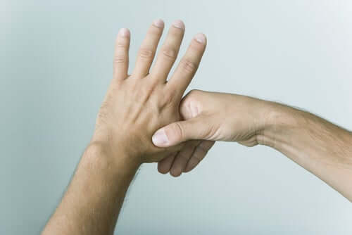 A person pressing on their fingers for eliminating stress.