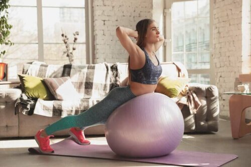 A woman doing exercise on a yoga ball.