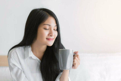 A woman enjoying her morning coffee.