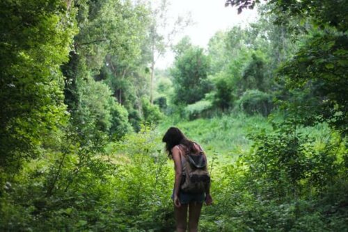 A woman hiking in the forest.