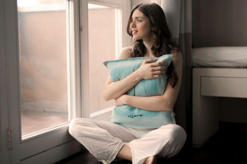 A woman hugging a pillow.
