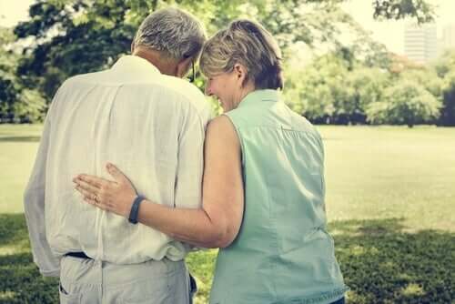 An elderly couple walking in the park.