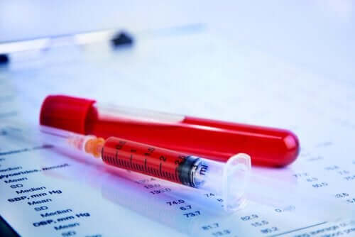 A syringe and a vial full of blood.