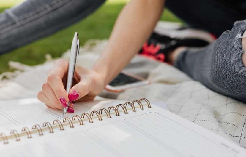 A young woman making a list.