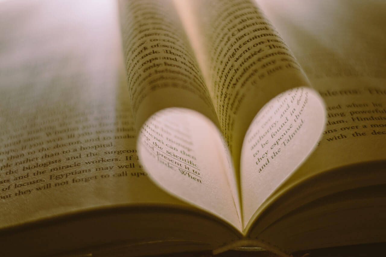 A book with the pages tucked inward, forming a heart.