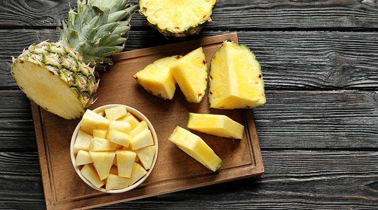 Pineapple on a cutting board.