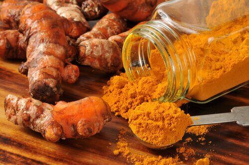 turmeric powder in jar and roots