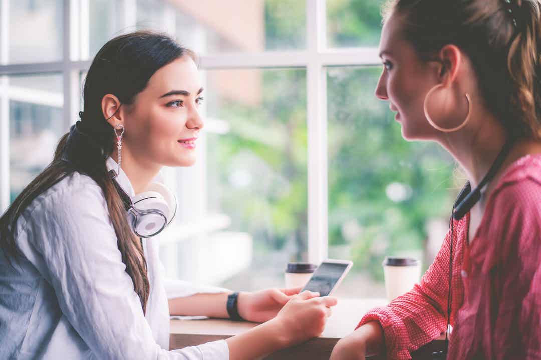 Two young women talking.