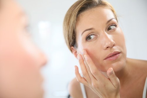 Woman applying eye cream