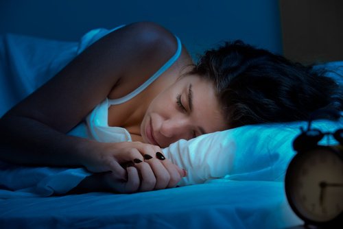 Woman sleeping in a dark room
