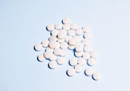A pile of aspirins on a surface.