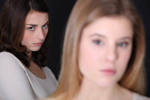 An envious woman starting at another woman.