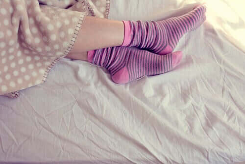A woman sleeping with socks on. 