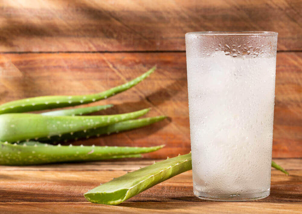 A glass of juice containing aloe vera.
