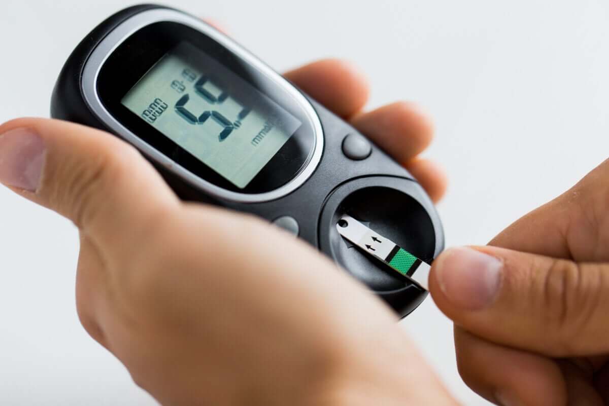 A person testing their blood sugar on a glucometer.