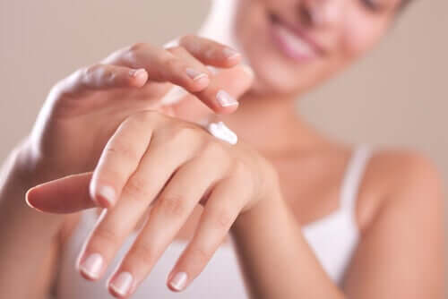 A woman applying hand cream.