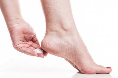 A woman removing her foot calluses.