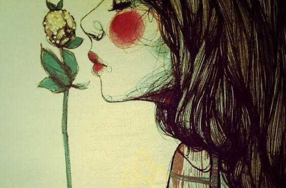 woman smelling a flower