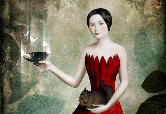 Woman holding a bird and feeding a squirrel