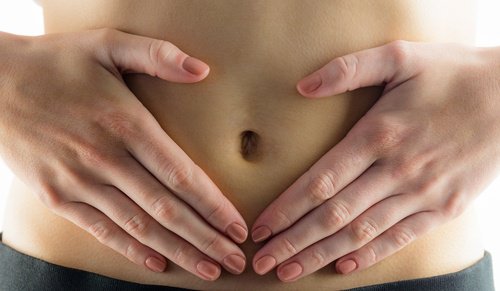 A person with their hands on their belly.