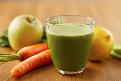 A smoothie with apples carrots and celery.