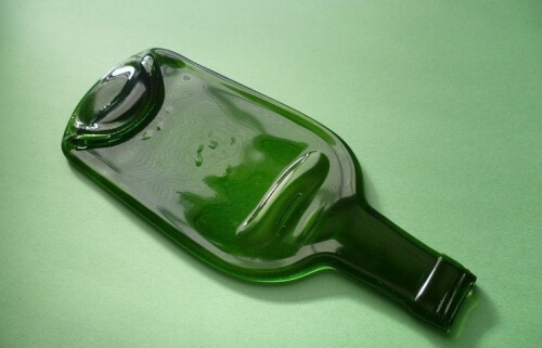 Make a glass bottle flat for a platter.