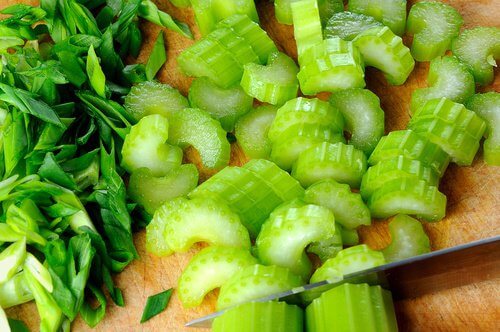 Celery stalks being sliced.